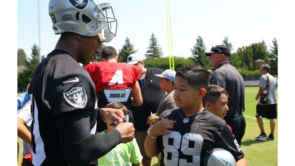 NFL players welcome boys and girls club kids to camps
